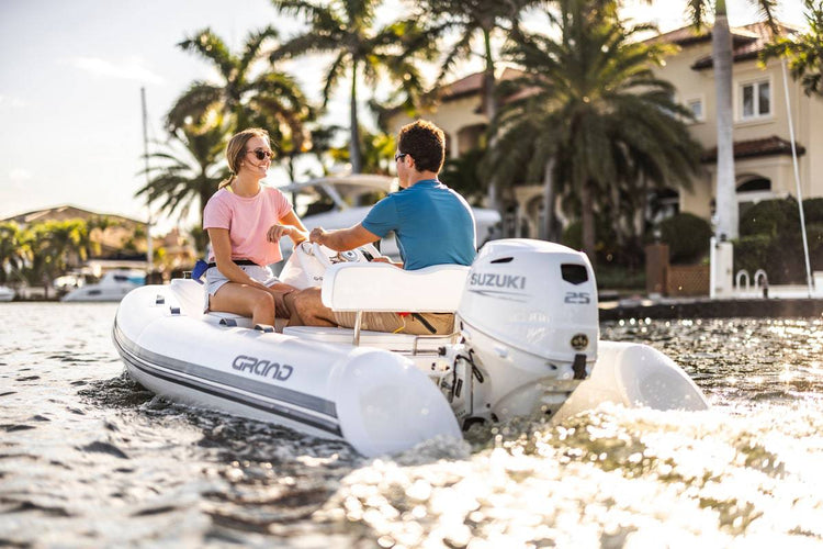 Suzuki 25 HP White Remote in Use on Dinghy Back View