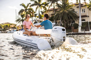 Suzuki 25 HP White Remote in Use Dinghy Back View